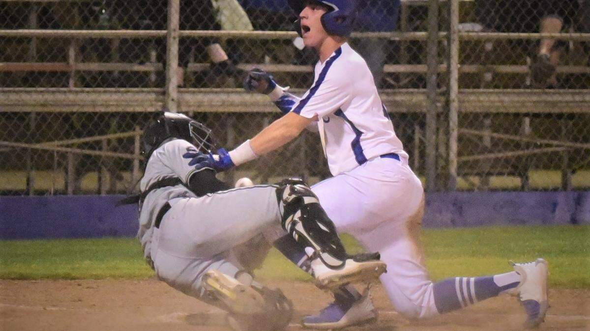 Atwater High senior Cole Hazel slides into the plate and topples over Buhach Colony catcher Gavin Ipock during the fourth inning of a game on Friday, March 26, 2022 at Memorial Ballpark in Atwater, Calif.