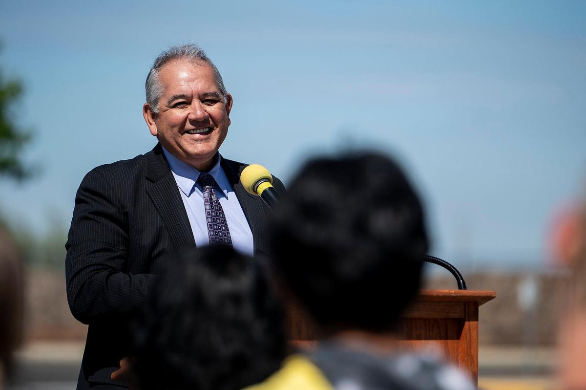 Merced Union High School District Deputy Superintendent of Human Resources and District Operations Ralph Calderon, speaks during a ceremony celebrating a Merced Union High School District’s renewable energy project at El Capitan High School in Merced, Calif., on Wednesday, April 13, 2022. Solar array structures have been installed at all Merced Union High School District parking lots and the panels are expected to supply the district with about 90% of its energy needs.