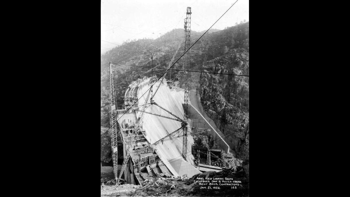 Aerial View of Exchequer Dam &amp; Powerhouse, January 21, 1926. C. E. Kocher, serving as MID President from 1923 to 1927, oversaw the construction of the Exchequer Dam and Powerhouse.