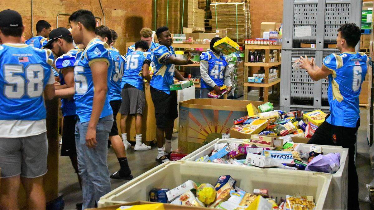 Members of the North high school football team help sort food at the Merced County Food Bank on Tuesday, June 18, 2019.