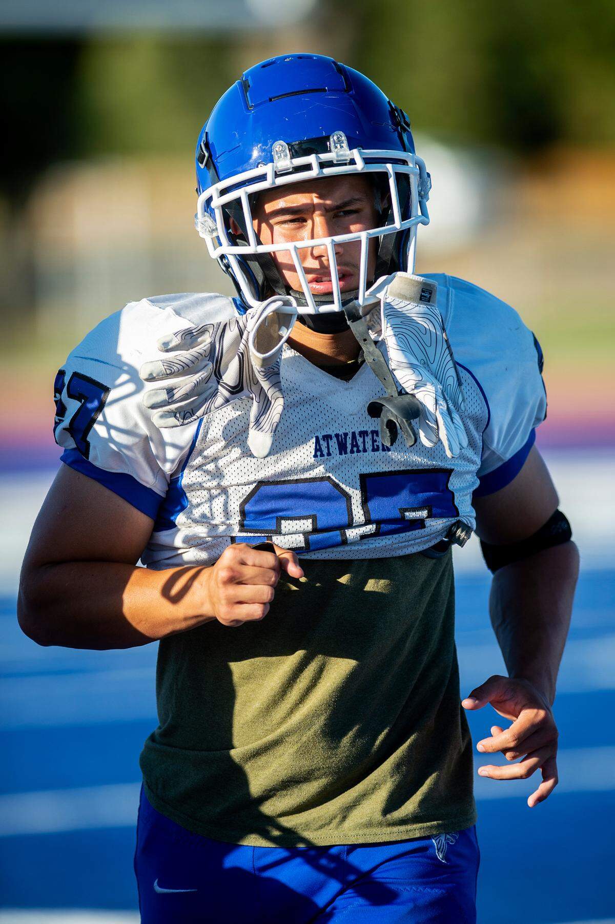 Jeremiah Delarosa jogs across the field during football practice at Atwater High School in Atwater, Calif., on Wednesday, Aug. 14, 2024.