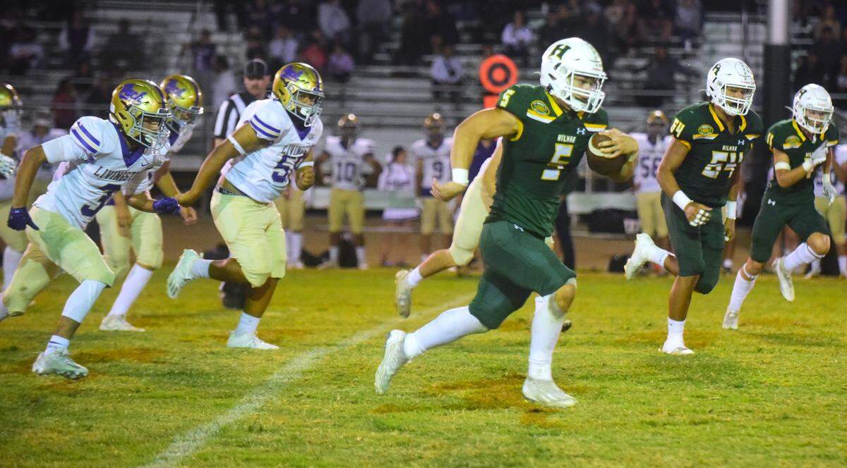 Hilmar High School running back Logan Cardoso (5) breaks free during a running play against Livingston on Friday, Sept. 29, 2023.