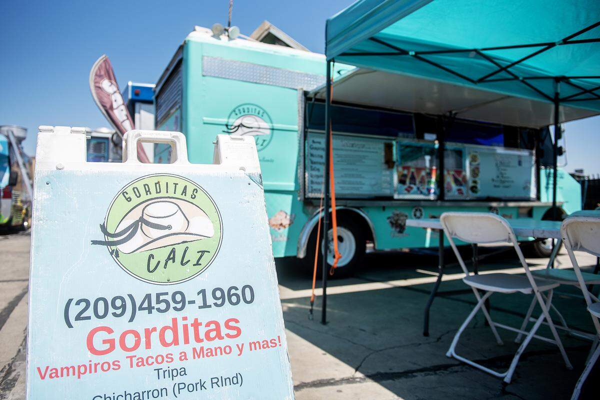The Gorditas Cali food truck serves lunch to customers in a food truck parking area in the lot of Courtesy Rent a Car, 1055 W. 15th Street in Merced, Calif., on Tuesday, Aug. 12, 2025. The location currently hosts up to nine food trucks offering various cuisine options. 