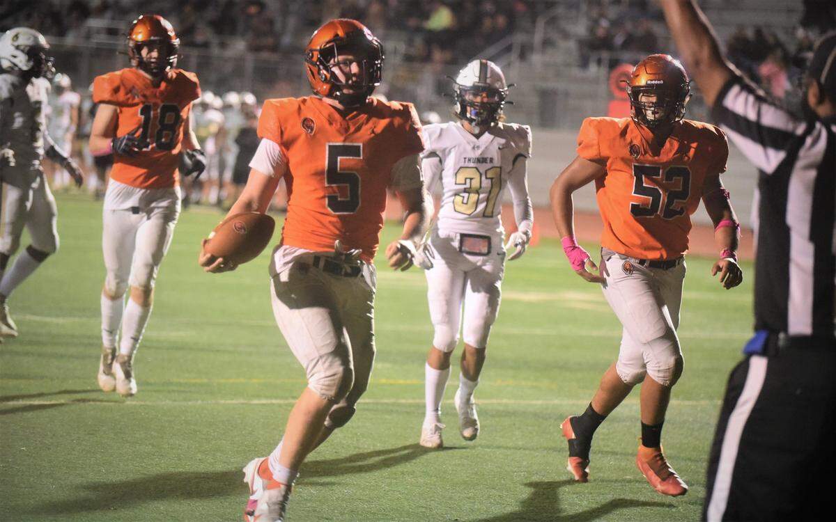 Merced High senior quarterback Seth Scheidt scores on a 10-yard run during the second half against Buhach Colony on Friday, Oct. 15, 2021 at Veterans Stadium in Merced, Calif.