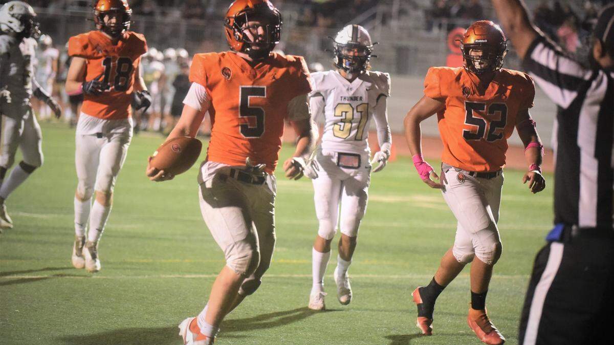 Merced High senior quarterback Seth Scheidt scores on a 10-yard run during the second half against Buhach Colony on Friday, Oct. 15, 2021 at Veterans Stadium in Merced, Calif.