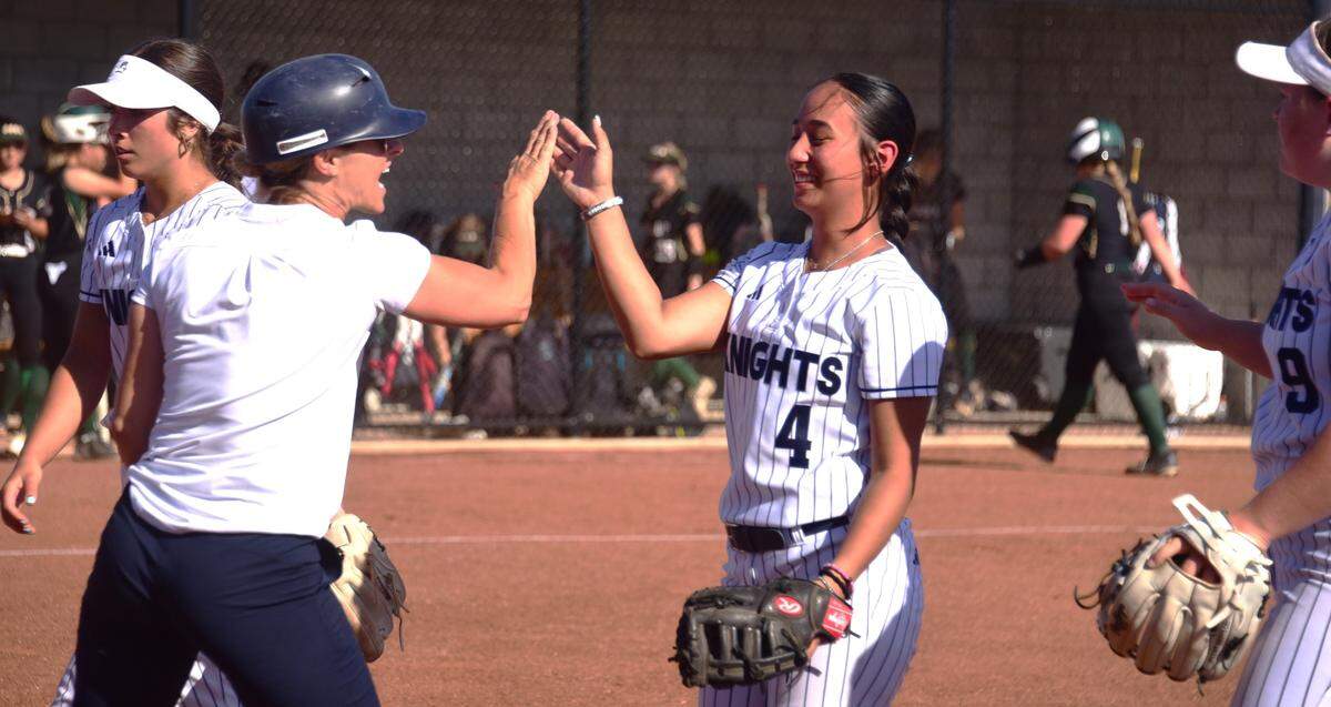 Stone Ridge Christian High coach Cathy Cole (left) celebrates with Knights first baseman Addyson Soto (4) after Soto made a key play to get out of an inning during a semifinal playoff game against Argonaut on Thursday, May 16, 2024.