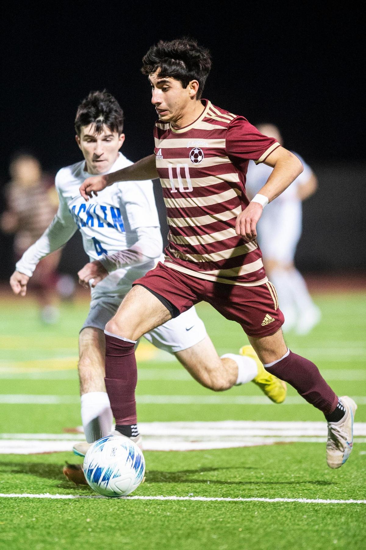 Golden Valley senior Joshua Perez dribbles past a defender (10) during a Division 2 playoff game against Rocklin at Golden Valley High School in Merced, Calif., on Tuesday, Feb. 13, 2024. The Cougars beat the Thunder 3-0.