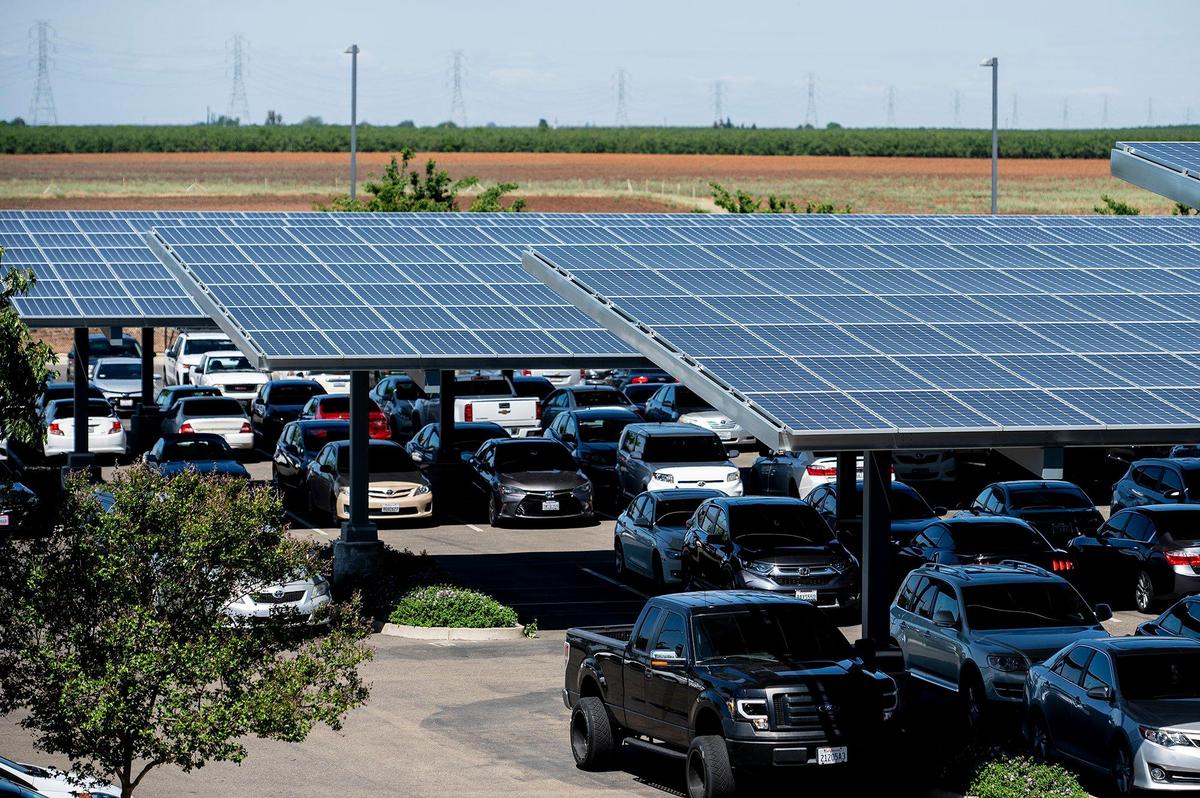 Solar panels in the parking lot of El Capitan High School in Merced, Calif., on Wednesday, April 13, 2022. Solar array structures have been installed at all Merced Union High School District parking lots and are expected to supply the district with about 90% of its energy needs.