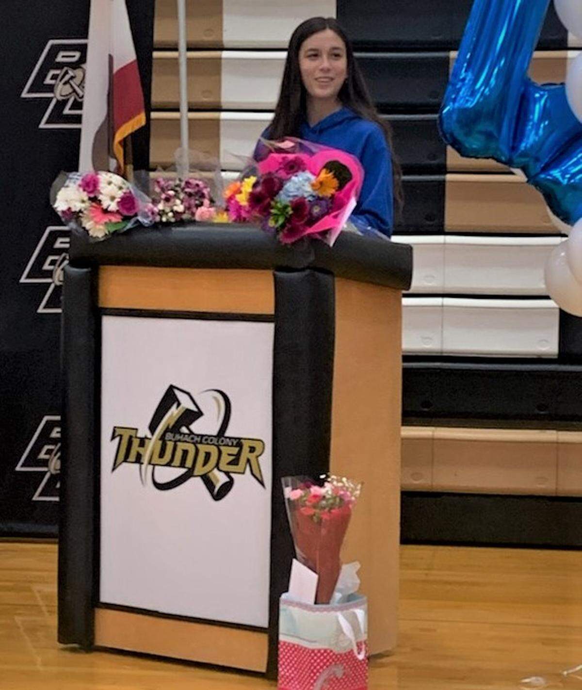 Buhach Colony senior Celina Henn speaks during a ceremony to celebrate her signing her national letter of intent to play volleyball at Wheaton College at the Buhach Colony Gym.