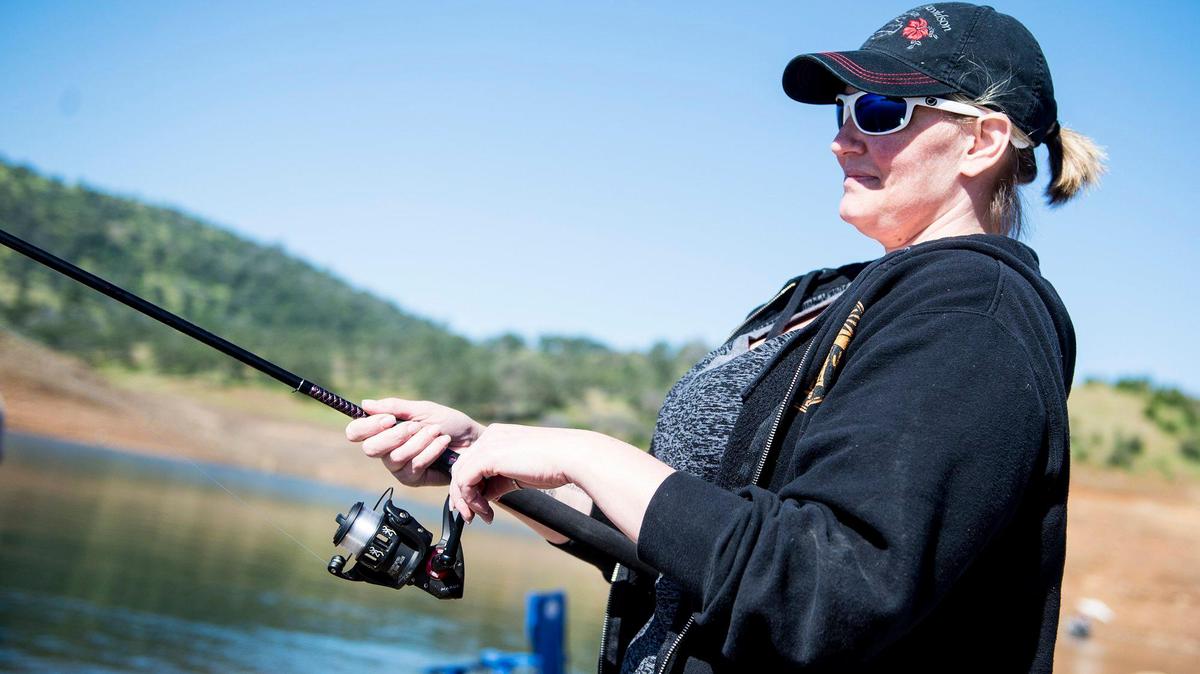 Barbara Enwia, 40, of Modesto fishes during the 2017 Spring Trout Derby in the Barrett Cove area of Lake McClure in Mariposa County, Calif., on Saturday, April 29, 2017.