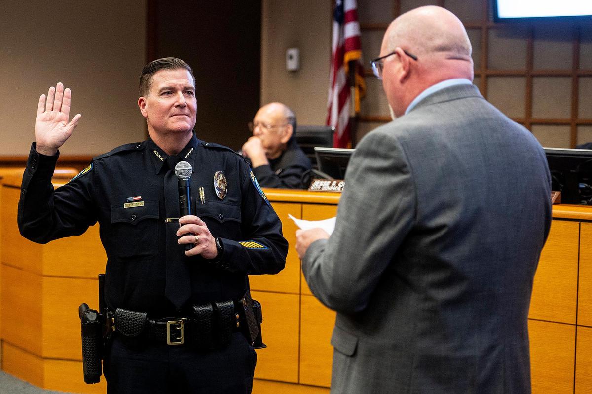 New Merced Police Chief Steven Stanfield, left takes the oath of office during a ceremonial swearing in by new Merced City Manger Scott McBride, right, during the Merced City Council meeting in Merced, Calif., on Monday, Nov. 6, 2023. Stanfield was officially sworn-in and took over police chief duties on Oct. 30.