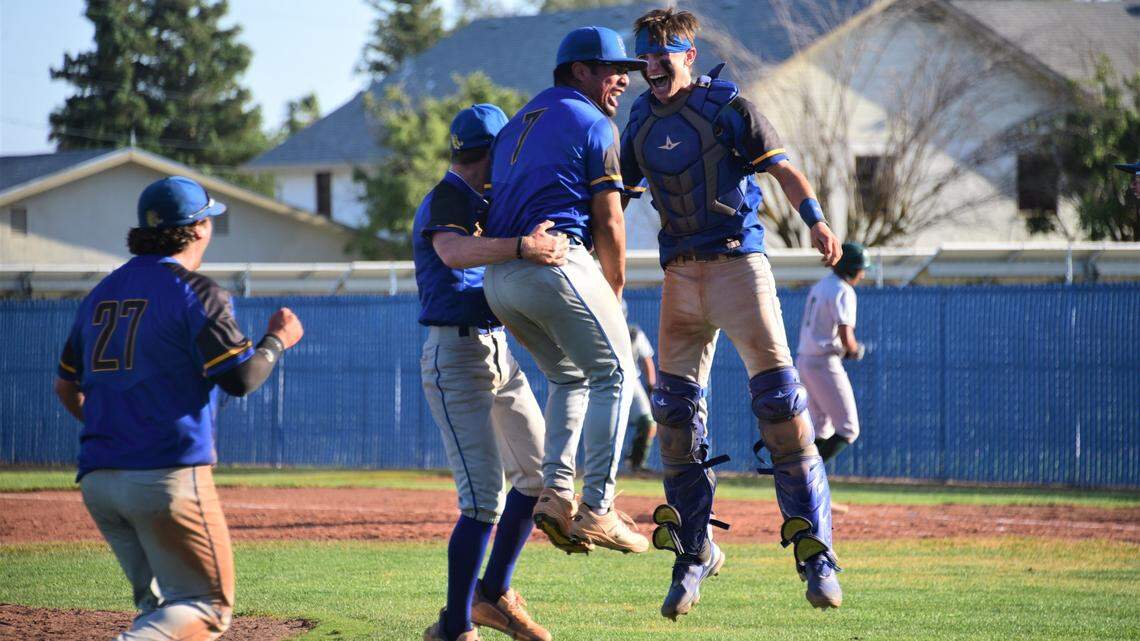 Dos Palos High School pitcher Isac Mandujano (7) celebrates with catcher Peyton Van Worth after the Broncos record the final out of a 4-3 victory over Dinuba in the Central Section Division III semifinal game on Tuesday, May 23, 2023 at Dos Palos High School.
