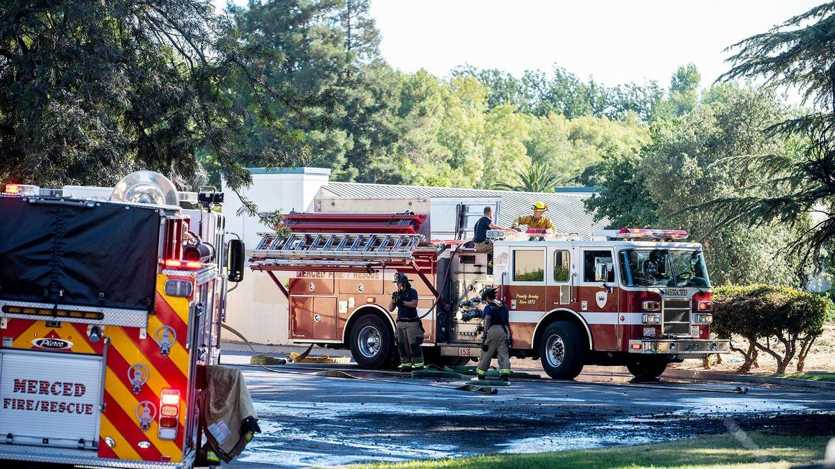 Firefighters prepare to leave the scene after extinguishing a tree fire near the In-Shape Health Club in the 2900 block of G Street in Merced, Calif., on Monday, June 20, 2022. According to fire officials, firefighters responded to the tree fire as well as three brush fires in the area Monday afternoon. Fire officials said the fires are being investigated as suspicious and may have been started by a person in the area.