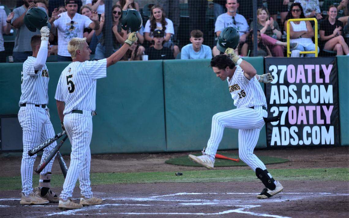 Kingsburg High School junior Holden Hirschkorn (15) crosses home plate after hitting a first-inning home run against Dos Palos in the Central Section Division III championship game on Thursday, May 25, 2023 at Valley Strong Ballpark in Visalia, Calif.