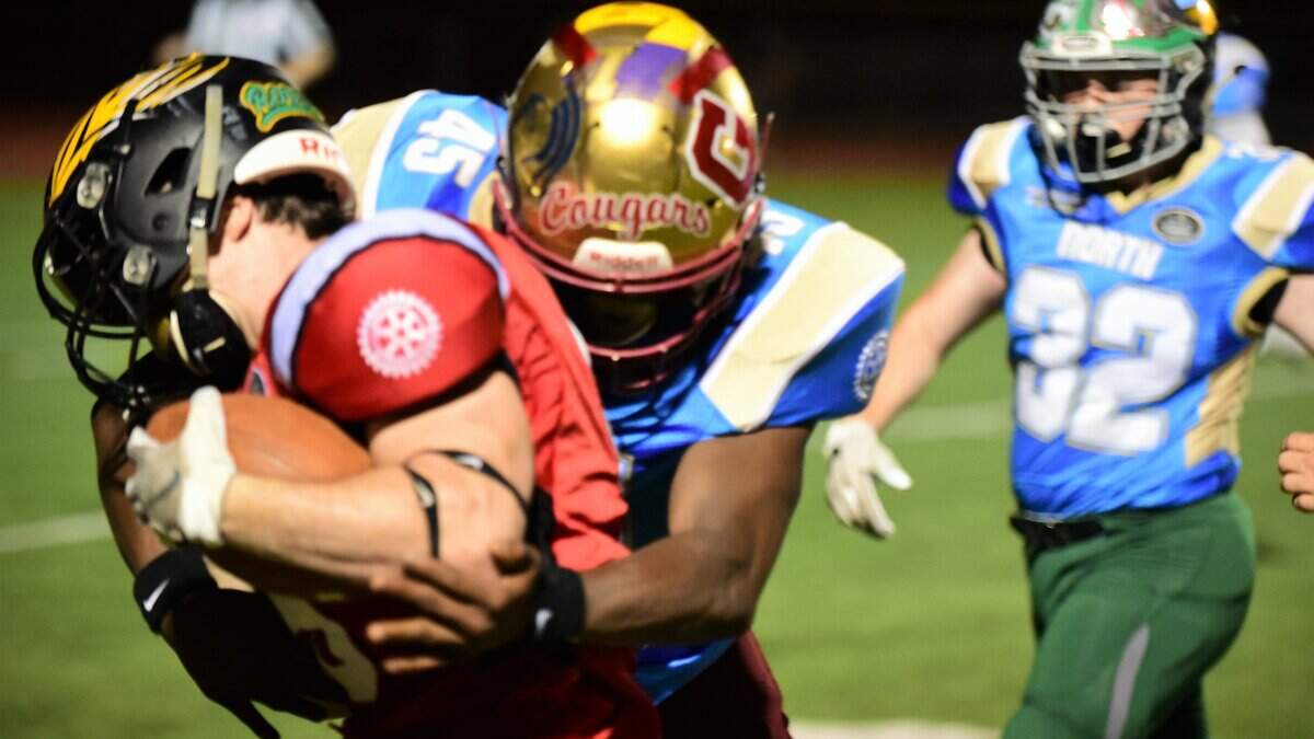 Former Golden Valley standout Davon Johnson tackles the South’s Jackson Schultz (Clovis North) during Saturday night’s 34th annual North/South Rotary Bob Green Football Classic at Veterans Stadium.