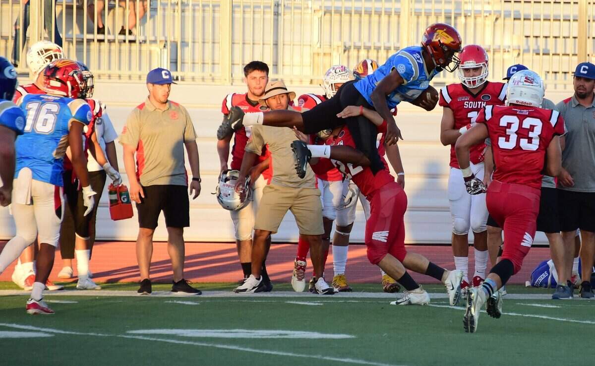 Former Merced High star Xavier Stewart leaps to get extra yardage on a fake punt in the first quarter of the 34th annual North/South Rotary Bob Green Football Classic on Saturday, June 22, 2019 at Veterans Stadium in Merced, Calif.