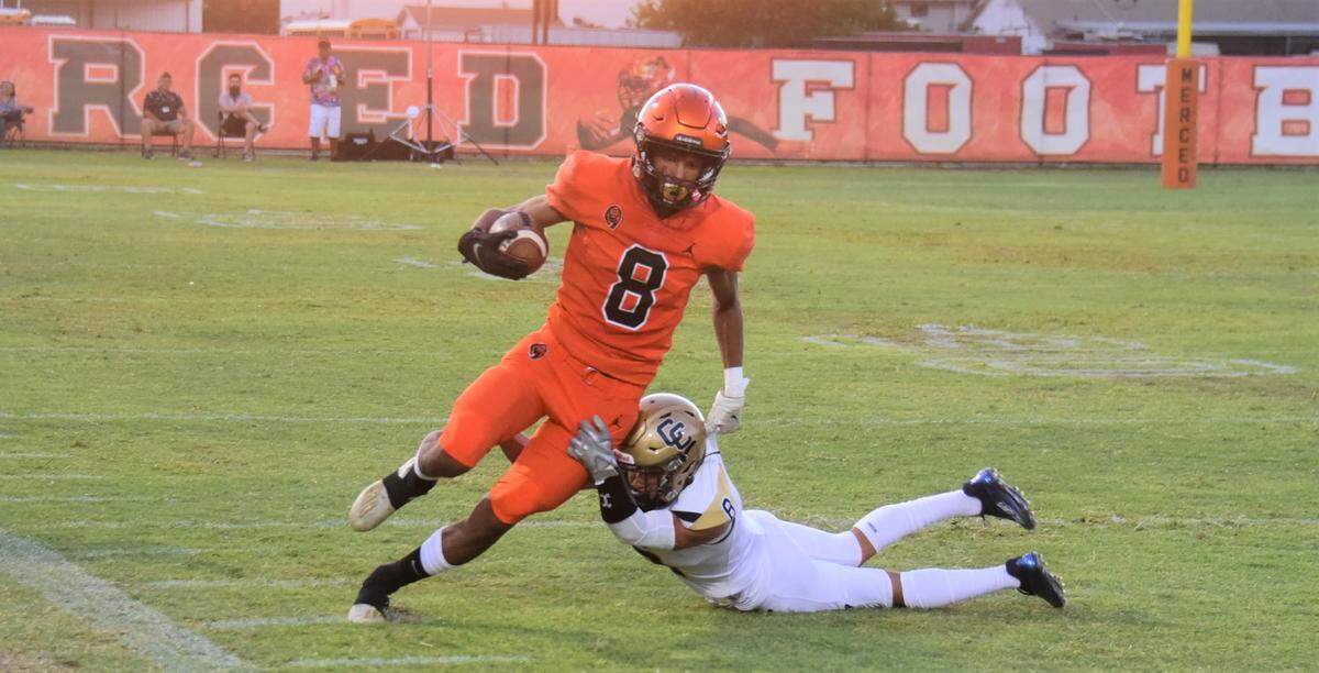 Merced High School senior receiver Enoch Evans runs up the field after catching a pass during a game against Central Catholic on Friday, Aug. 19, 2022 at Cathie Hostetler Stadium.