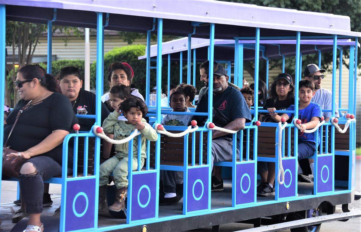 People ride the tram around the Merced County Nut Festival on Saturday, Oct. 22, 2022 at the Merced County Fairgrounds.