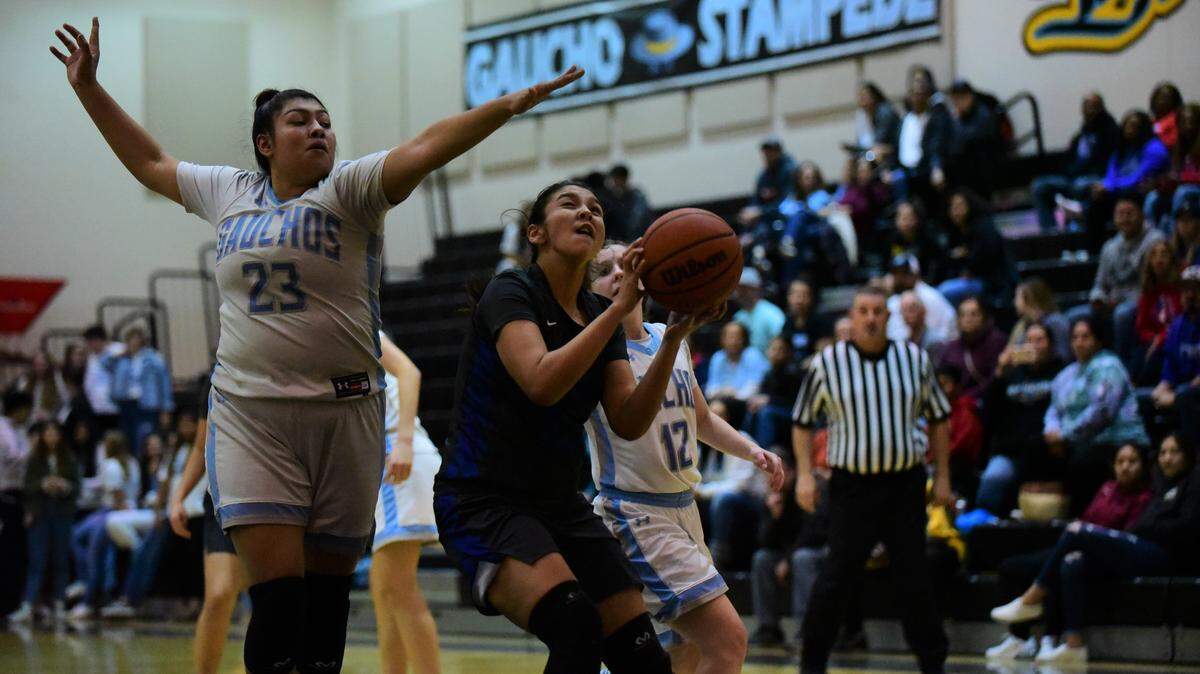 Atwater High sophomore Maya Manzanares goes up for a shot against El Capitan’s Rosealyn Delgado during a game on Tuesday night.