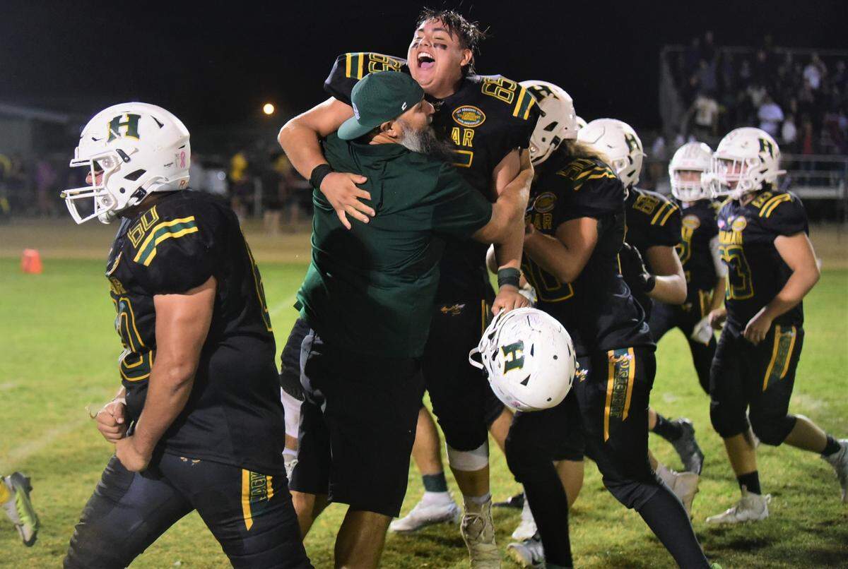 Hilmar High football players celebrate after their thrilling 21-20 win over Escalon on Friday, Sept. 30, 2022 at Hilmar High School.