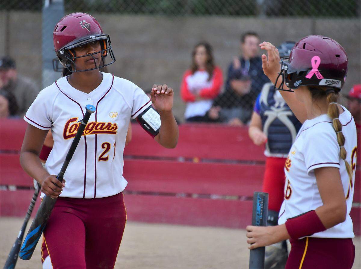 Golden Valley High freshman Naomi Moore receives a high-five from teammate Maddy Stokes after scoring the first run of the game in the fifth inning against East Union on Wednesday afternoon at Golden Valley High in Merced, Calif.