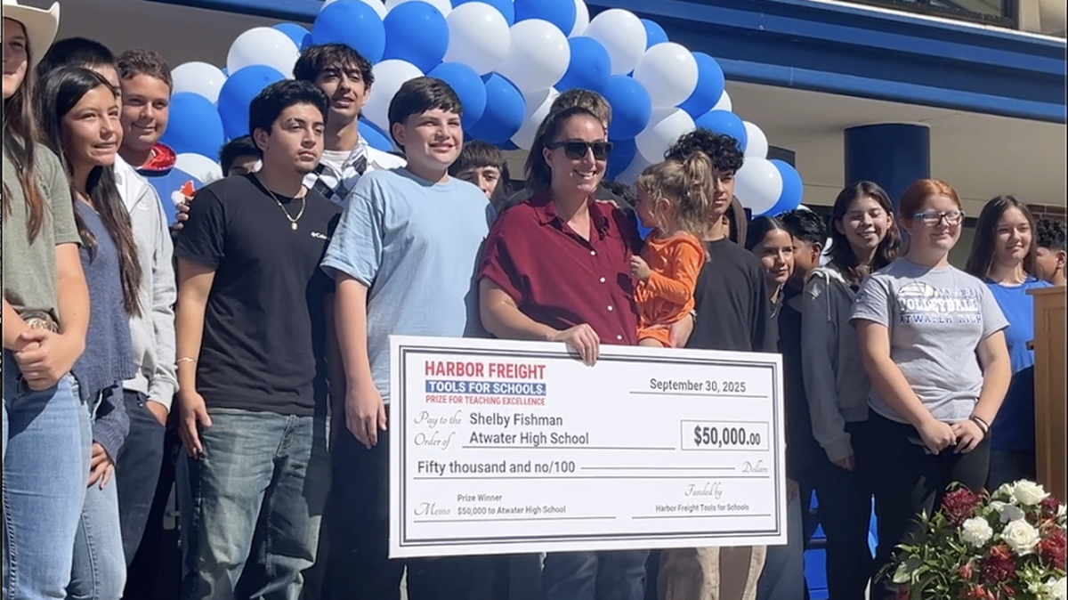 Atwater High School teacher Shelby Fishman poses with a ceremonial $50,000 check from Harbor Freight. Fishman was named one of 25 winners of the 2025 Harbor Freight Tools for Schools Prize for Teaching Excellence. The school will use the money to upgrade student tool kits and invest in projects for the advanced small engines class.