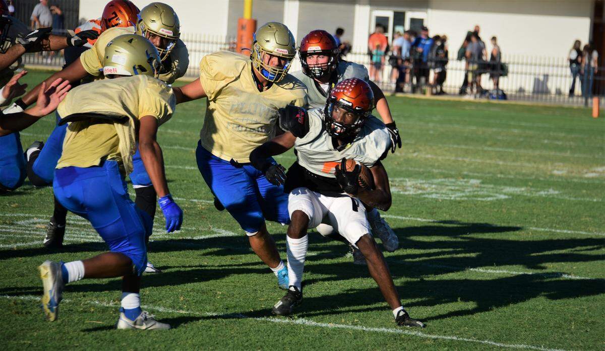 Merced High School junior Chase Smith will play key roles for the Bears at running back and defensive back this season. Here Smith runs the ball during a scrimmage against Clovis on Friday, Aug. 12, 2022 at Cathie Hostetler Stadium in Merced, Calif.
