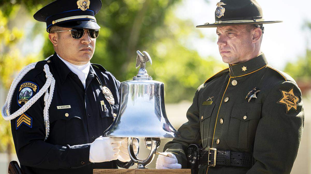 Law enforcement officers toll a bell as the names of the Merced County’s fallen law enforcement officers are read aloud during the annual Merced County Peace Officers Memorial Ceremony in Merced, Calif., on Wednesday, May 29, 2024.