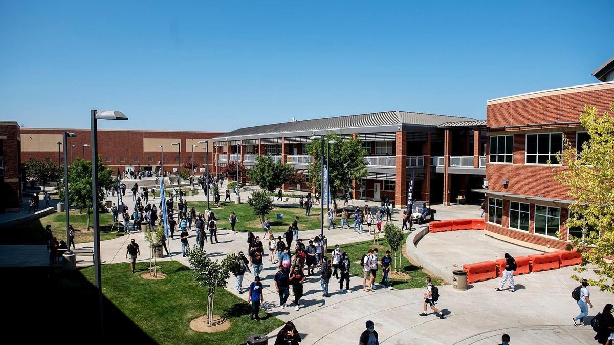 Students walk across campus during the first day of school at El Capitan High School in Merced, Calif., on Wednesday, Aug. 11, 2021.