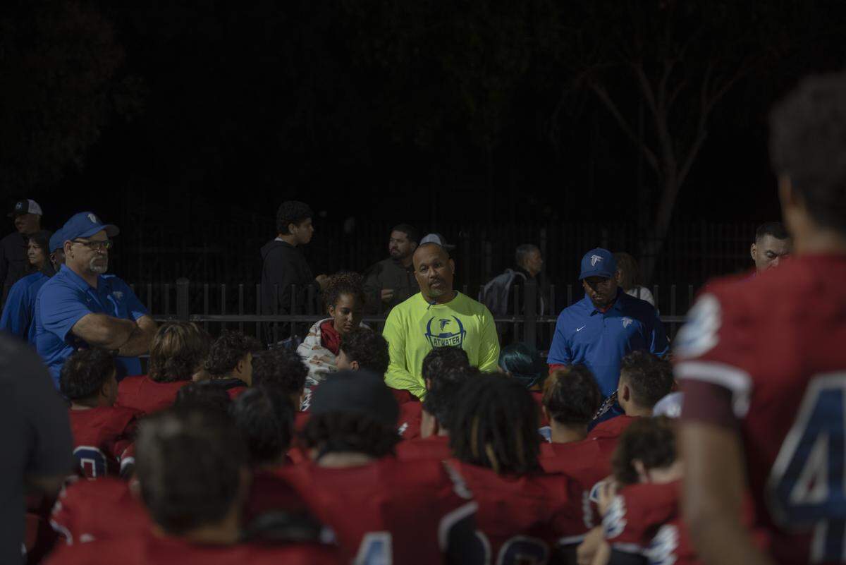 Atwater head coach Seneca Ybarra talks with his team following a 49-14 loss to Merced in Central California Conference play on Friday, Oct. 24, 2025.