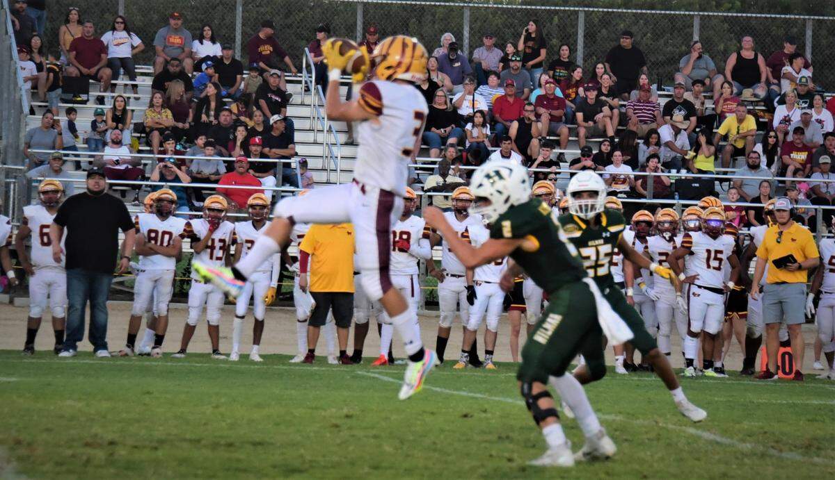 Los Banso High School receiver Jamison Braniff goes up for a catch against Hilmar on Friday, Aug, 26, 2022.