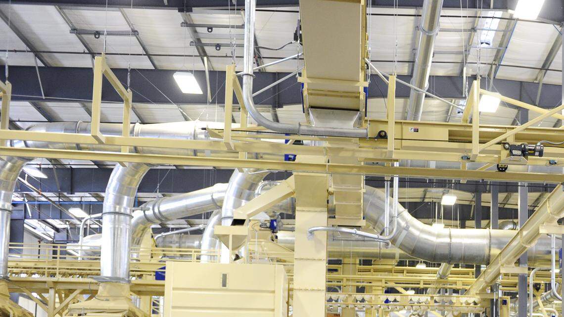 Industry representatives, and almond growers and processors from the region, talk over lunch, inside the new hulling and shelling processor, at Minturn Huller Cooperative in Chowchilla on Friday (6-27-14).