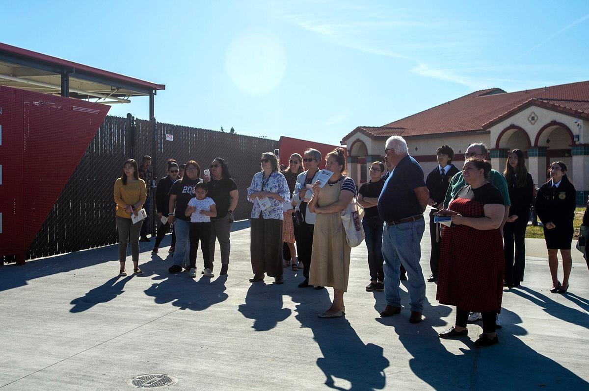 Students and members of the public look on during a ribbon cutting ceremony to celebrate the opening of the new Career and Technical Education building on the Delhi Unified School District campus in Delhi, Calif., on Tuesday, April 9, 2024. According to the district, classes in agricultural mechanics and welding will be offered to students beginning in the fall of 2024.