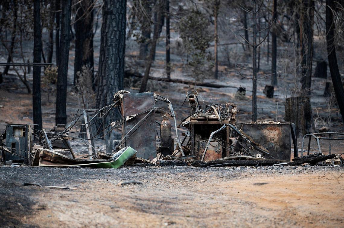 Charred items on a property along Jerseydale Road as firefighters continue to battle the Oak Fire in Mariposa County, Calif., on Tuesday, July 26, 2022.