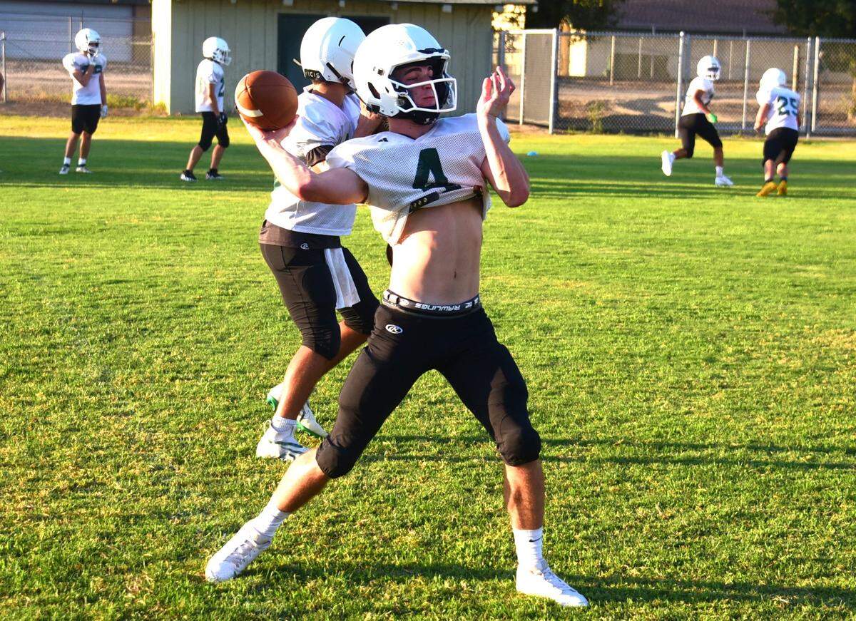 Hilmar High senior quarterback Merek Ellred throws a pass during practice on Tuesday, Aug. 6, 2024.