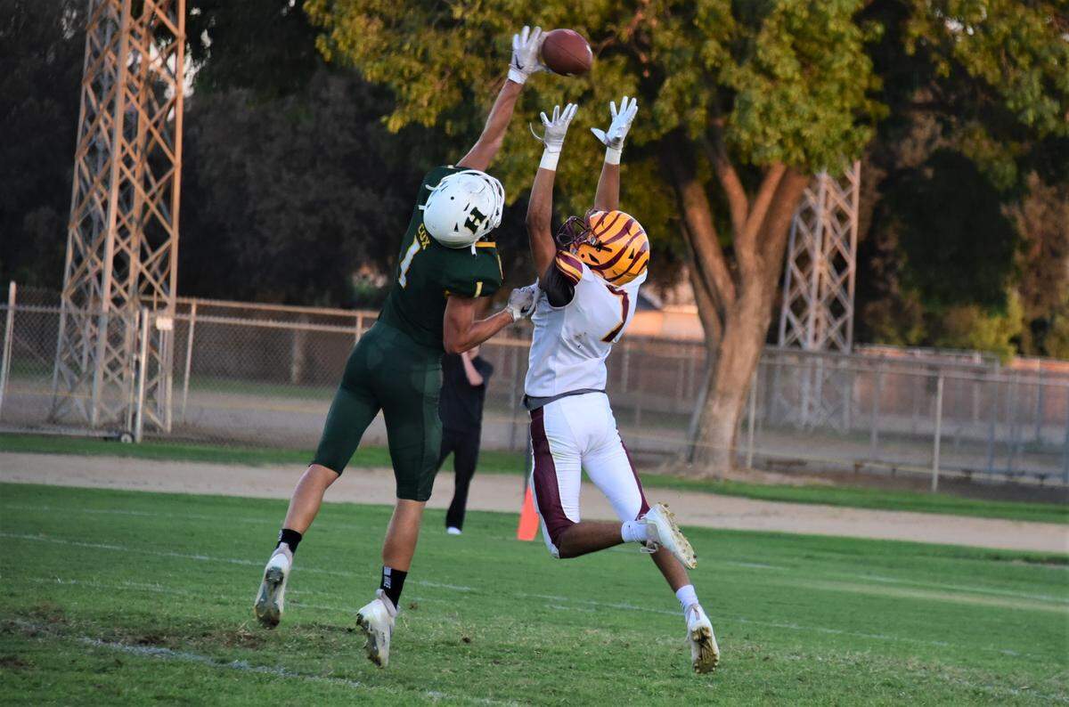 Hilmar High School senior Luke Cox deflects the ball away from Los Banos receiver George Garcia (7) during the Yellowjackets’ 21-7 win over Los Banos on Friday, Aug. 26, 2022.