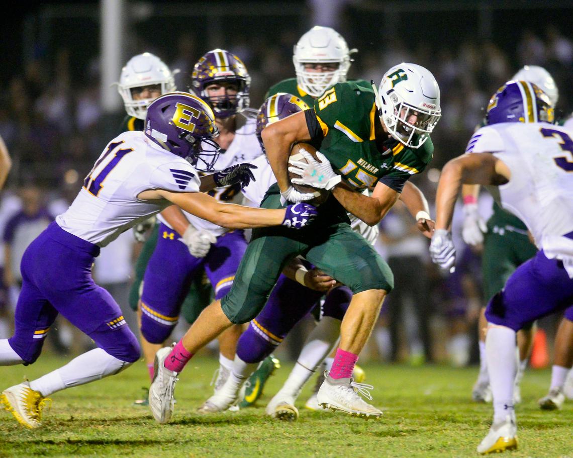 Hilmar running back Cole Bailey (13) runs past Escalon defenders during a game between Hilmar High School and Escalon High School at Hilmar High School in Hilmar California on September 20, 2019.
