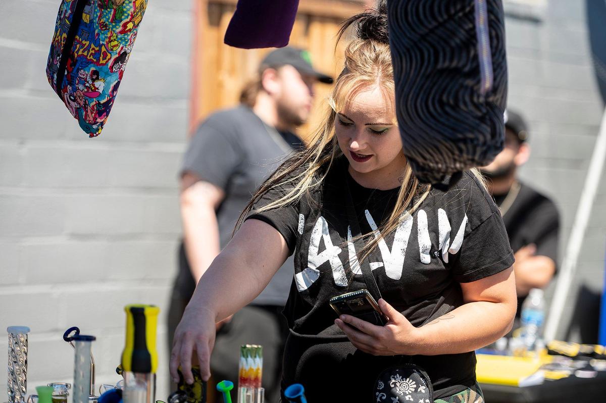 Melanie Punneo, 31, of Gustine, checks out pipes for sale during a 420 celebration on Third Avenue in Gustine, Calif., on Wednesday, April 20, 2022. The event included smoke shop items for sale, food vendors and live music.