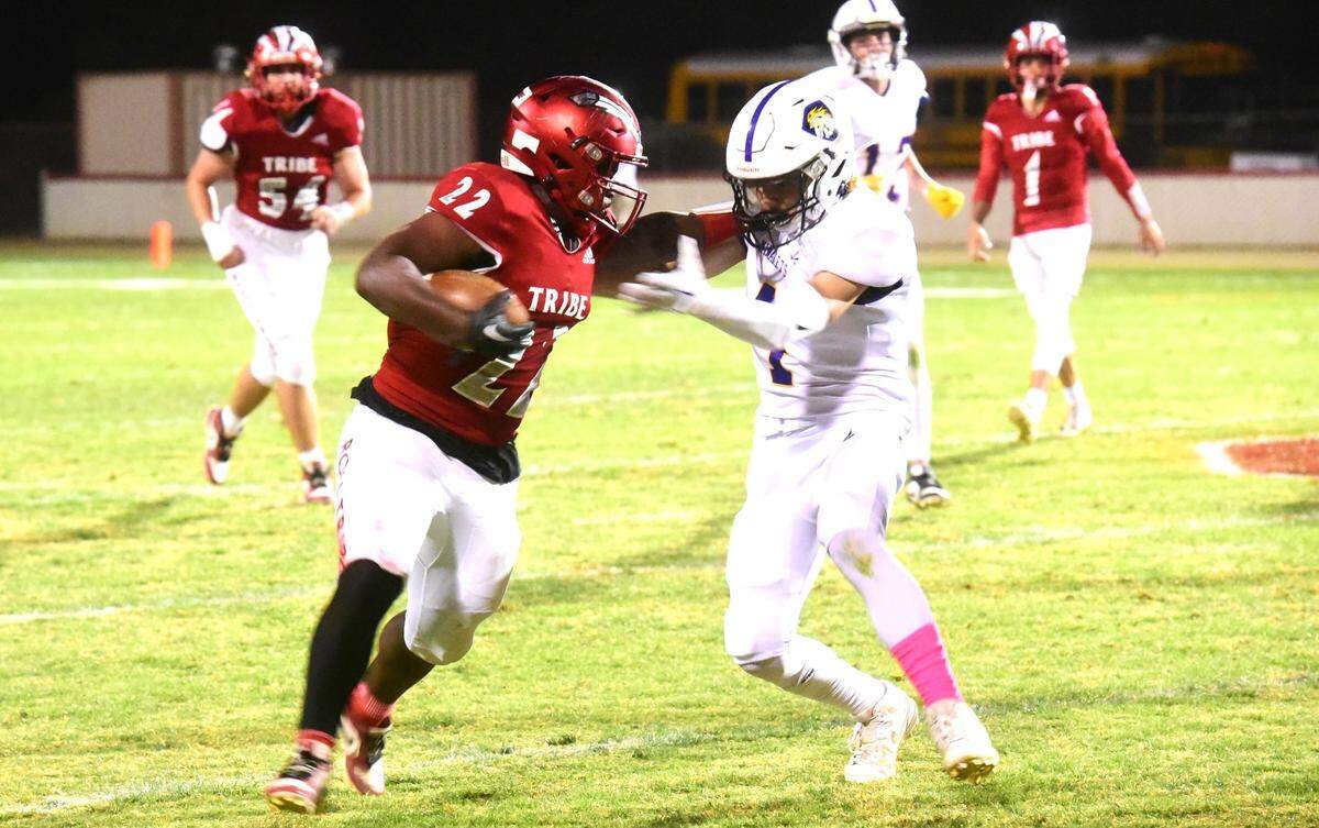Chowchilla High running back Dwayne Hemphill (22) stiff-arms a defender as he runs the ball up field during a game against Minarets on Friday, Oct. 18, 2024.