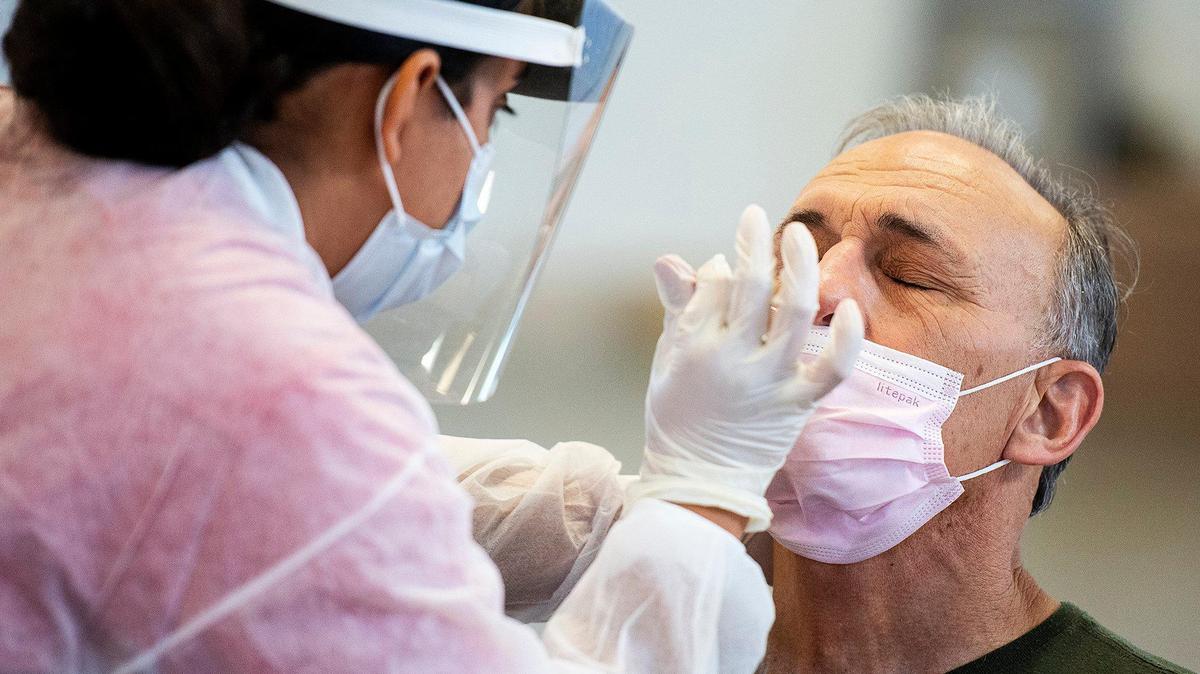 A sample is collected from 65-year-old Merced resident Jaime Ortega at a COVID-19 testing site located at the Merced County Fairgrounds in Merced, Calif., on Monday, May 4, 2020. According to the Merced County Department of Public Health, the new test site is thanks to a partnership with the State of California and OptumServe, a private health services company contracted by the state. The site is one of 80 locations across the state and will allow for more than 100 additional tests a day.