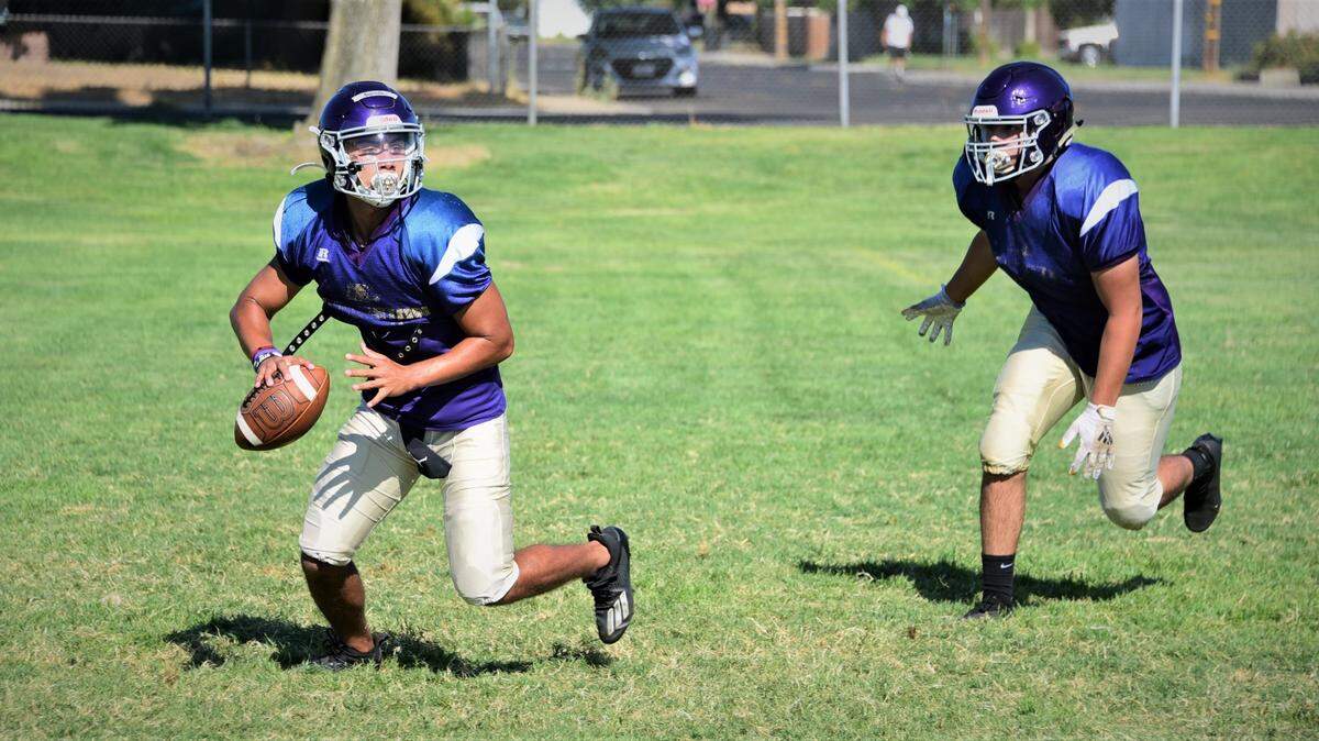 Livingston quarterback Rocklin Baptista scrambles during practice on Thursday, Aug. 5, 2021.