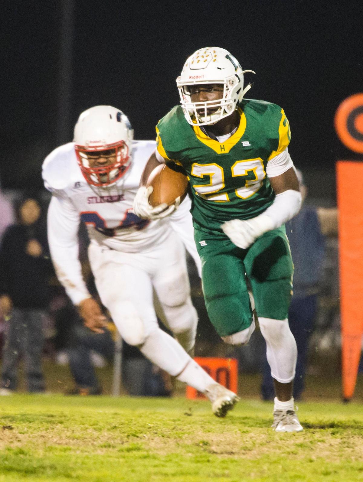 Issac Sharp, 23, of Hilmar High works his way upfield with Strathmore High closing in during the CIF State 6-AA High School Football State Championships at Hilmar High Saturday Dec. 15, 2018.