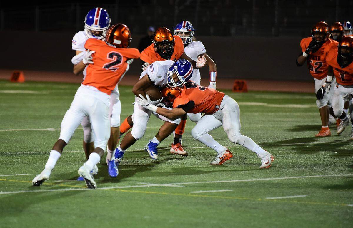 Atwater High running back James Thomas collides with Merced linebacker Xavier Ortiz-Wilson during the 50th Sante Fe Bowl on Friday, Oct. 25, 2019 at Veterans Stadium in Merced, Calif.