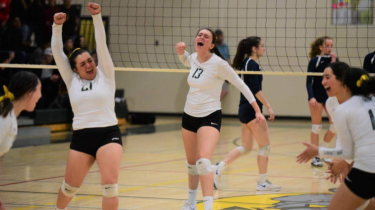 Le Grand’s Alexis Aguallo (21) and Priscilla Barnett (13) celebrate with the rest of their volleyball teammates after scoring the final point in a 3-1 win over Urban of San Francisco in a Northern California Regional Playoff match on Tuesday, Nov. 12, 2019 at Le Grand High.