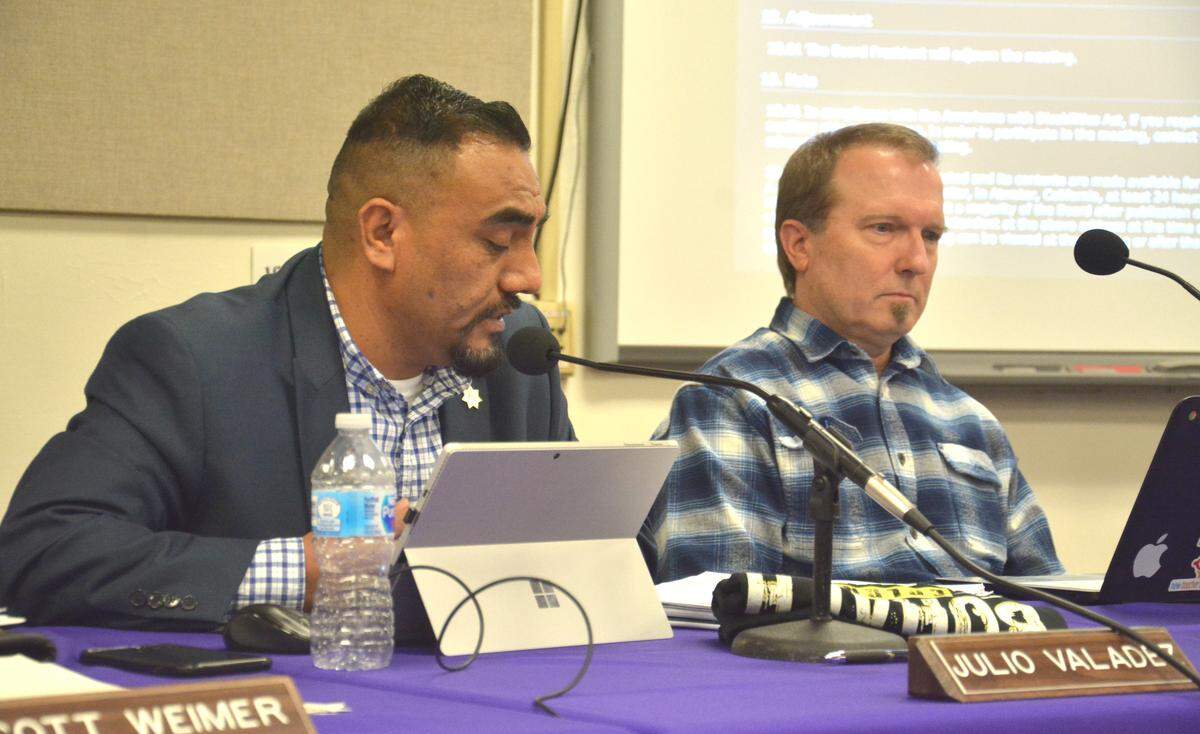 Board members Julio Valadez (left) and John Medearis speak at the Jan. 9, 2019 Merced Union High School District school board meeting. Board members were discussing whether to suspend an initiative creating a school board member so the newly elected members can have their say.