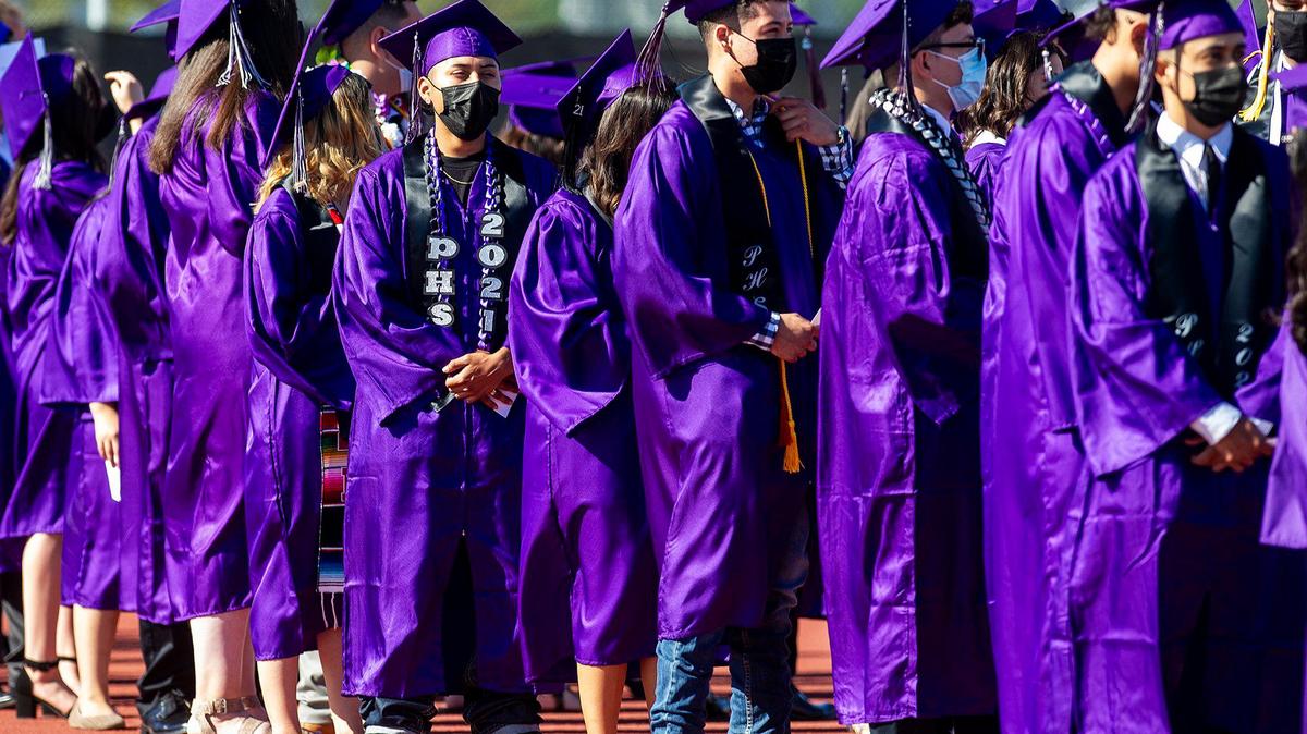 Graduates line up as they prepare to walk onto the field during a commencement ceremony for the Pacheco High School class of 2021 at Pacheco High School in Los Banos, Calif., on Monday June 14, 2021.