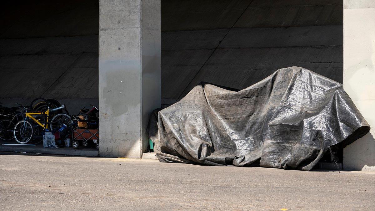 Various items and a makeshift shelter located along 15th Street under the Highway 99 overpass in Merced, Calif., on Tuesday, April 12, 2022.