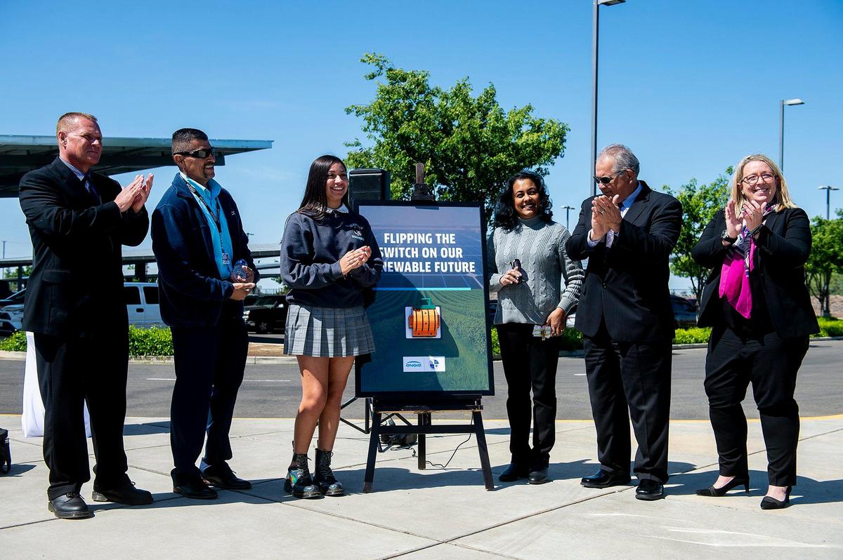 A ceremonial switch is flipped while celebrating the Merced Union High School District’s implementation of renewable energy at El Capitan High School in Merced, Calif., on Wednesday, April 13, 2022. Solar array structures have been installed at all Merced Union High School District parking lots and the panels are expected to supply the district with about 90% of its energy needs.