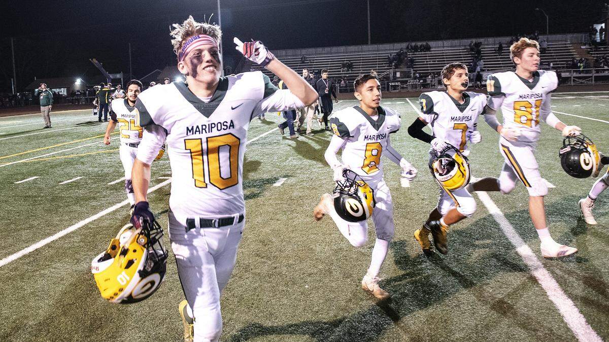 Mariposa’s Tyler Richards and teammates signal to the the crowd after their 17-14 Sac-Joaquin Section Division VII championship win over Denair on Friday at Turlock High School in Turlock, Calif., Friday, Nov. 22, 2019.