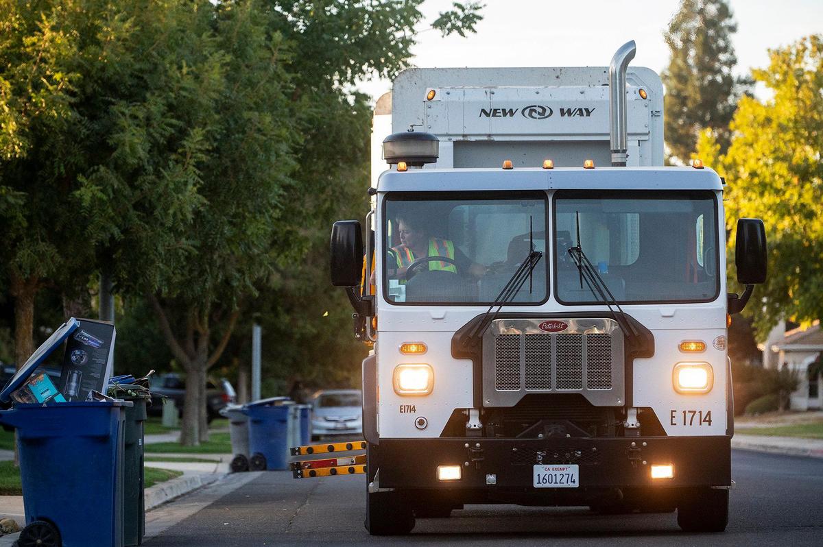 Merced Refuse Equipment Operator Kristie Light, 56, drives her route collecting refuse in Merced Calif. on Thursday, Oct. 24, 2024. According to Light who previously drove commercial trucks across parts of the country and would routinely be gone for 70-80 hours a week, her current job with the city allows her to spend more time at home. “It’s nice to go to work and like your job,” said Light.